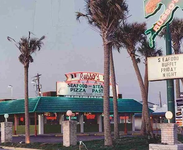 Russo's Seafood Restaurant with palm trees, green roof
