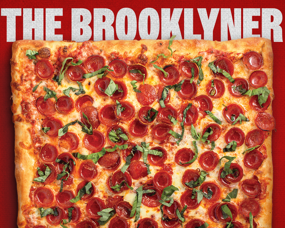 The Brooklyn-style square pizza with pepperoni and basil on a red background.
