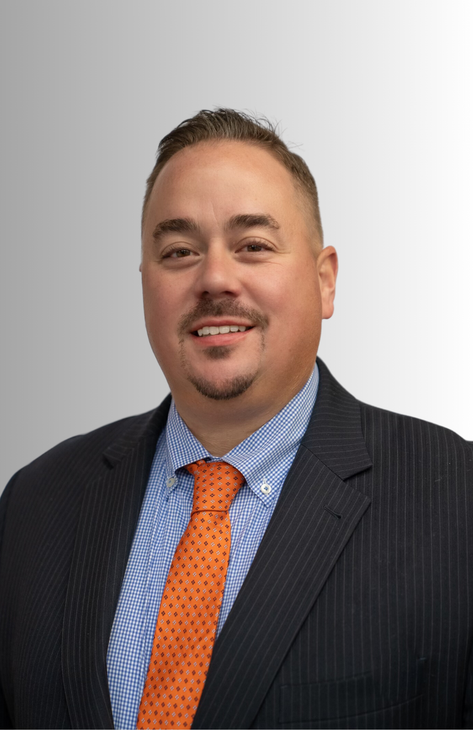 a man in a suit and tie is smiling for the camera .