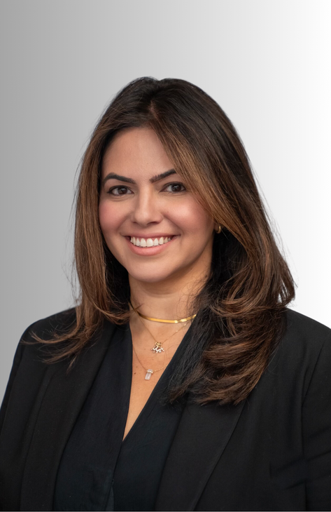 a woman in a white shirt is smiling for the camera .