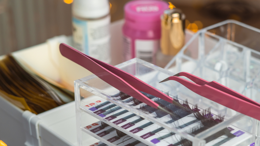 Manicure tools and nail polish bottles in a clear organizer tray