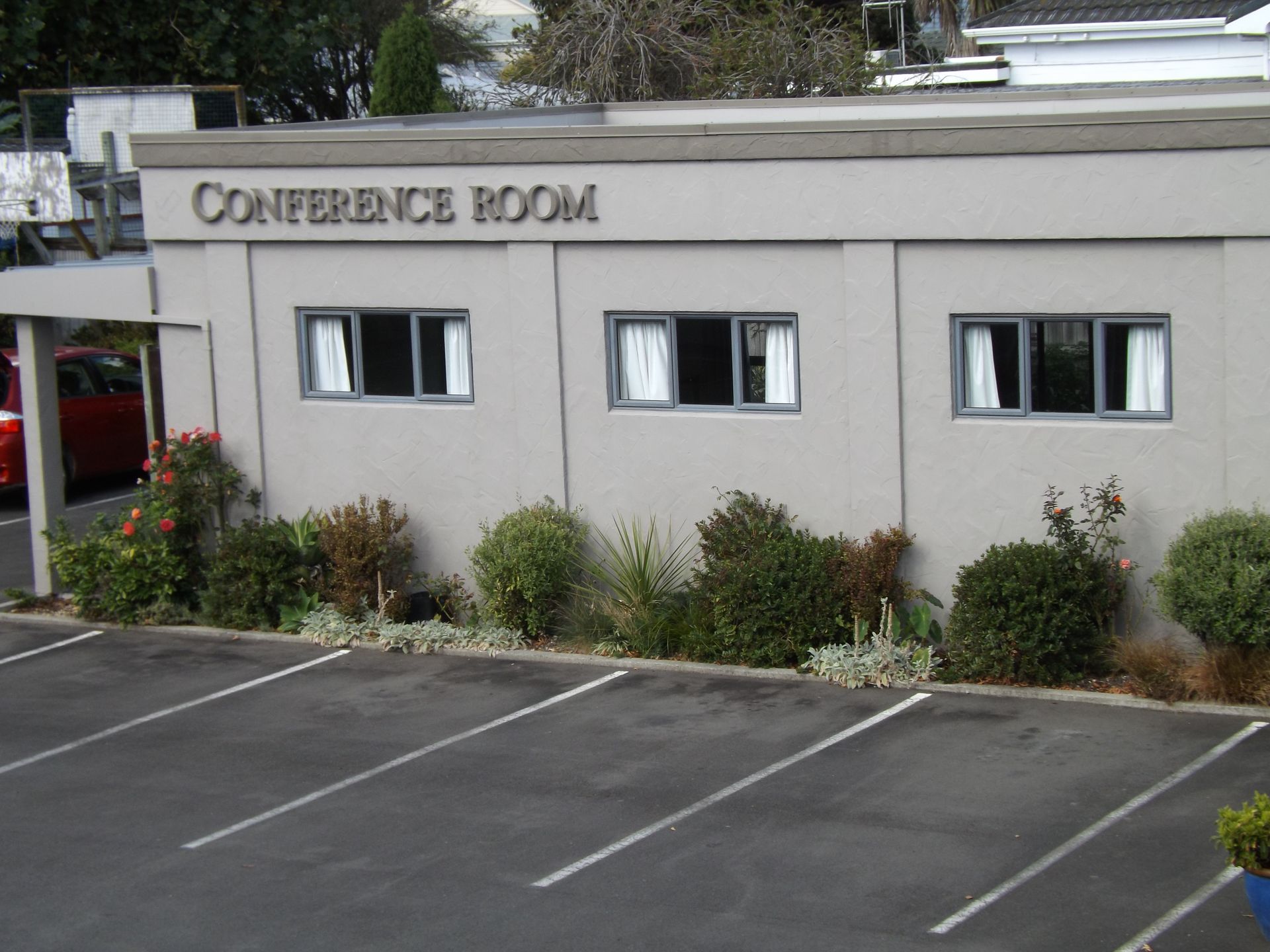 A conference room with a parking lot in front of it