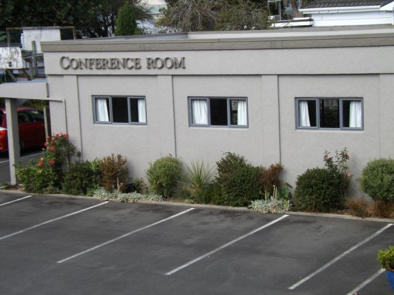 A conference room with a parking lot in front of it