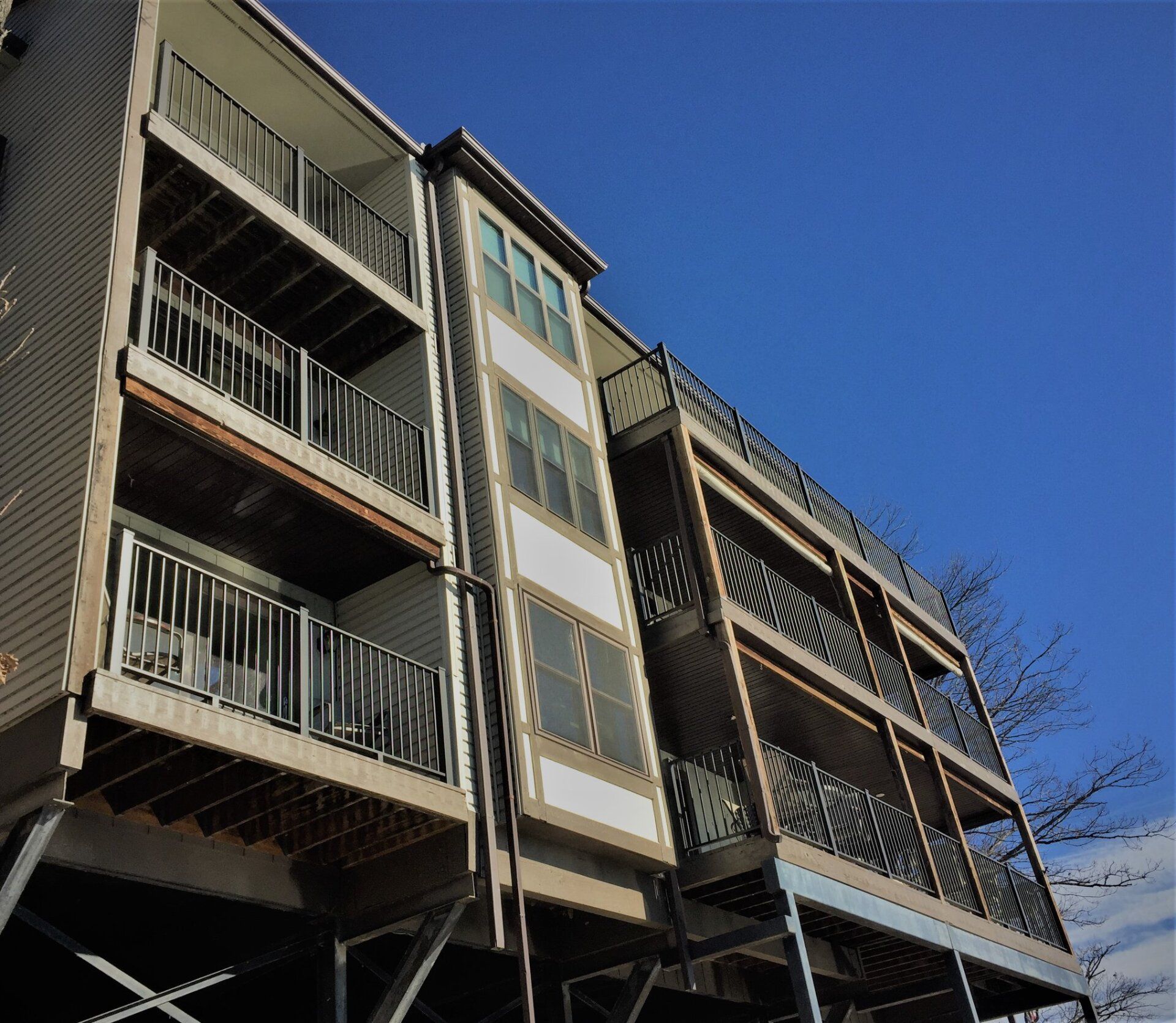 Apartment building with balconies against a clear blue sky