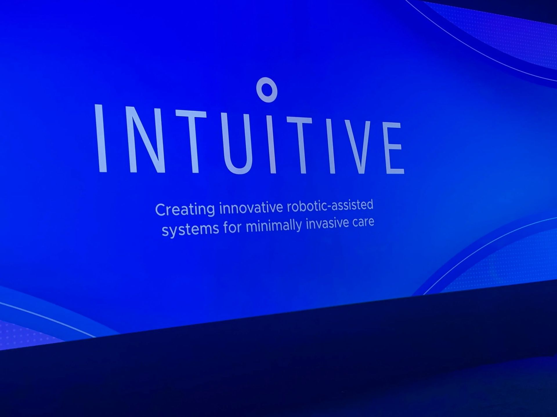 Blue title slide with the word “INTUITIVE” and a small tagline on a wavy abstract background