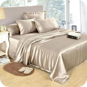 Silky beige bed with pillows, slippers, and a book tray in a bright, modern bedroom