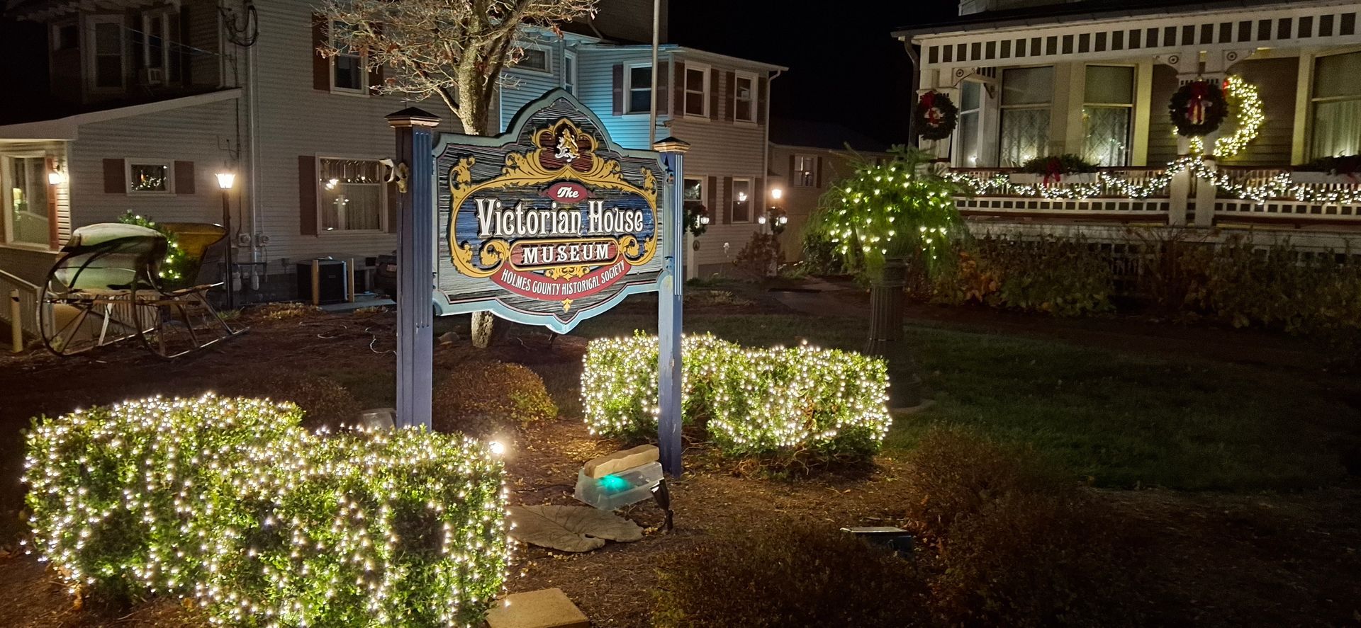 A nighttime photo of a sign with the words