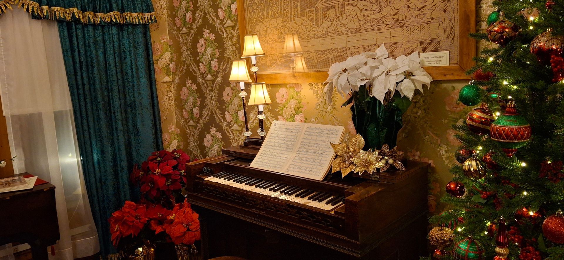 Christmas tree and piano decorated for the holidays.