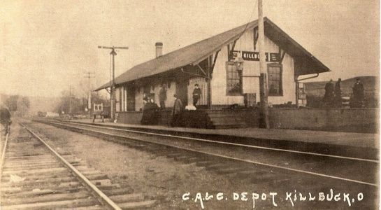 Vintage photo: Erie Railroad depot in Killbuck, Ohio, with tracks, building, and figures.