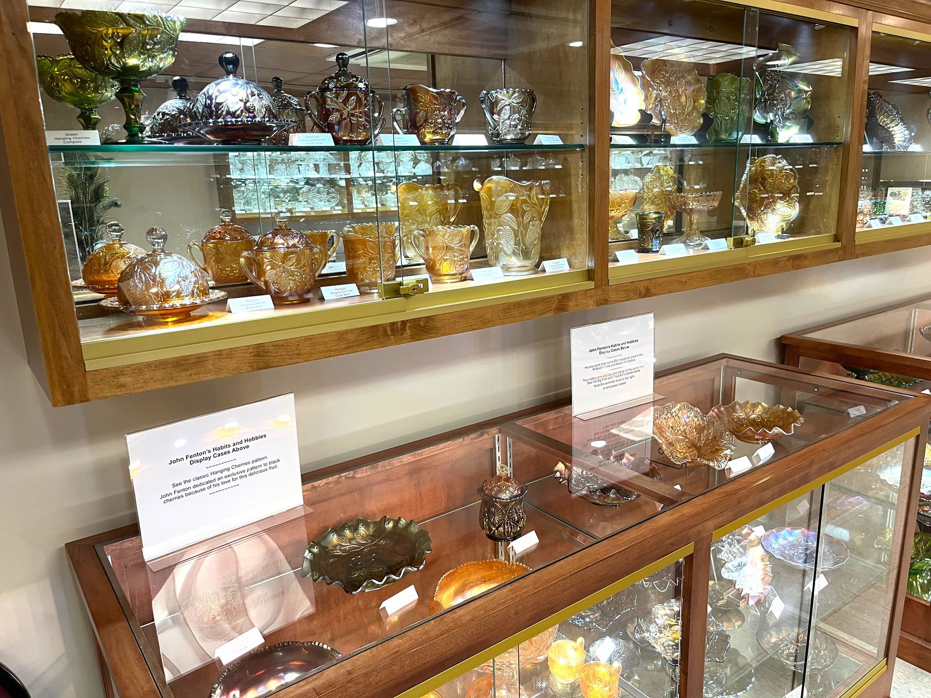 Glassware displayed in lit wooden cabinets.