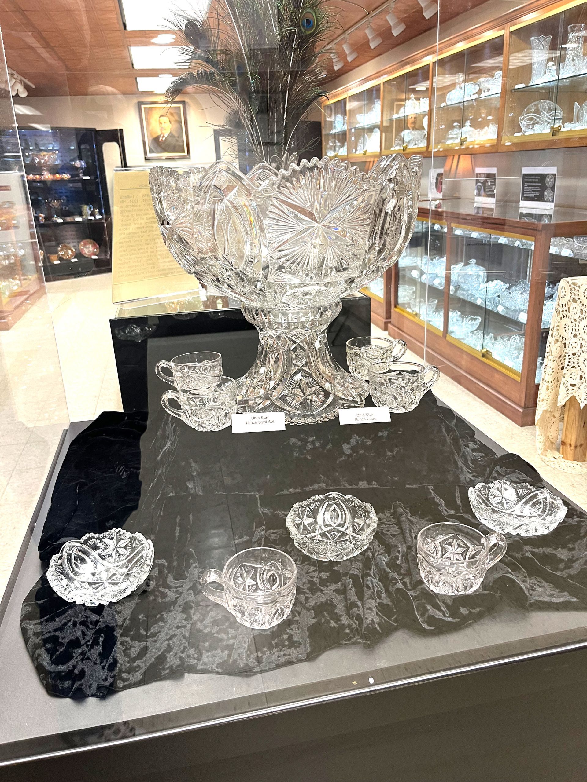 Ornate crystal punch bowl set on display in a store.