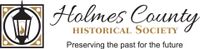 Logo of Holmes County Historical Society: Lamp icon within a square frame with text,