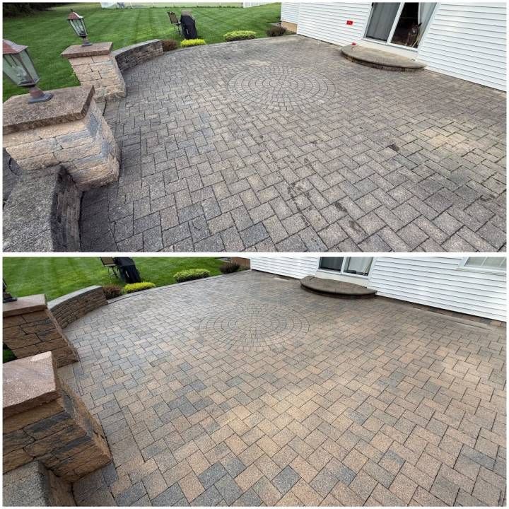 Before-and-after view of a cleaned brick patio beside a house and lawn.