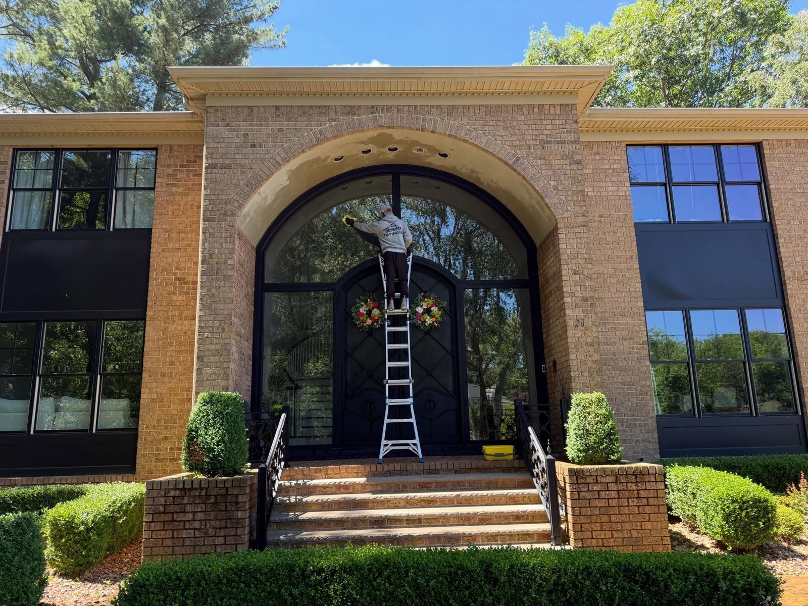 Brick arched entry, ladder at door — Catanzaro's Power Washing