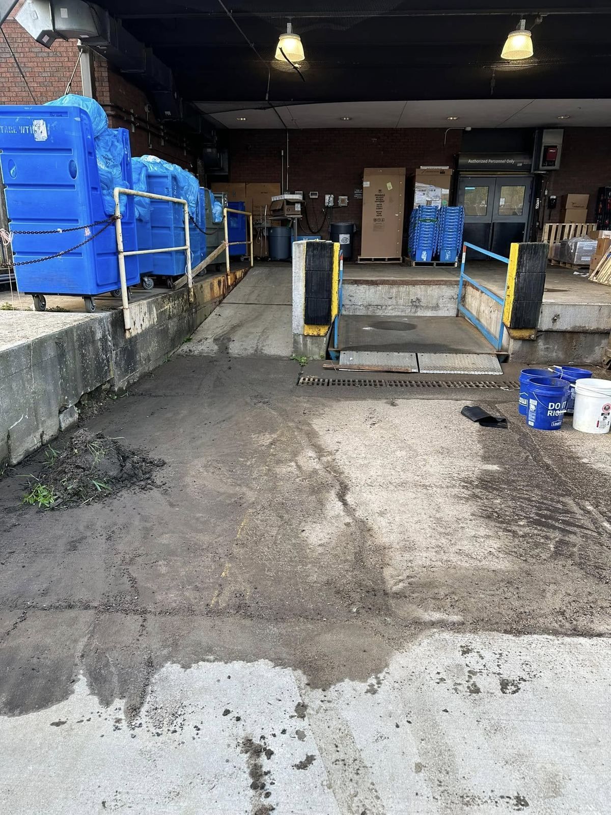 Garage/warehouse floor being power washed — Catanzaro's Power Washing