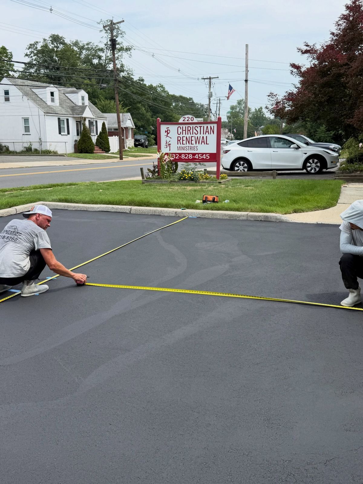 Crew measuring parking lot layout — Catanzaro's Power Washing