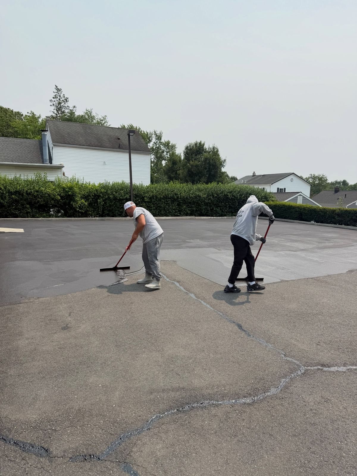 Crew sealing parking lot — Catanzaro's Power Washing