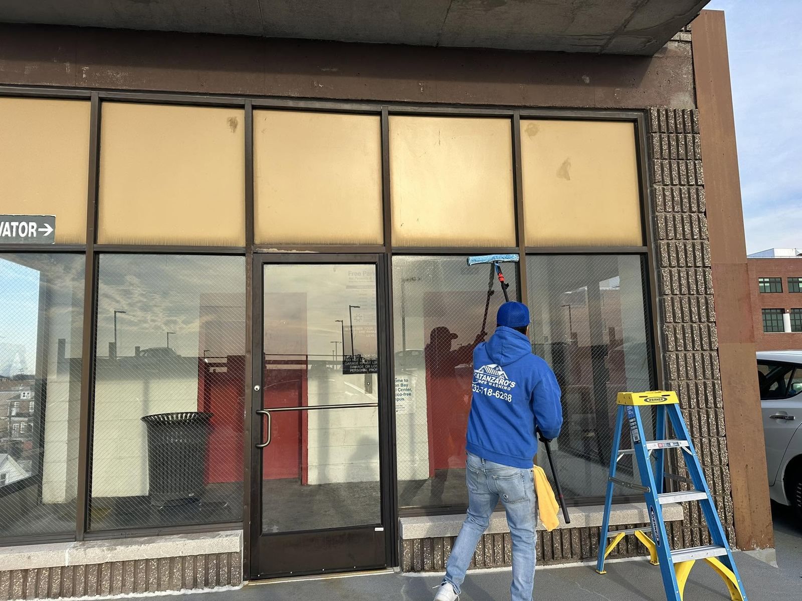 Storefront glass, crew washing windows — Catanzaro's Power Washing