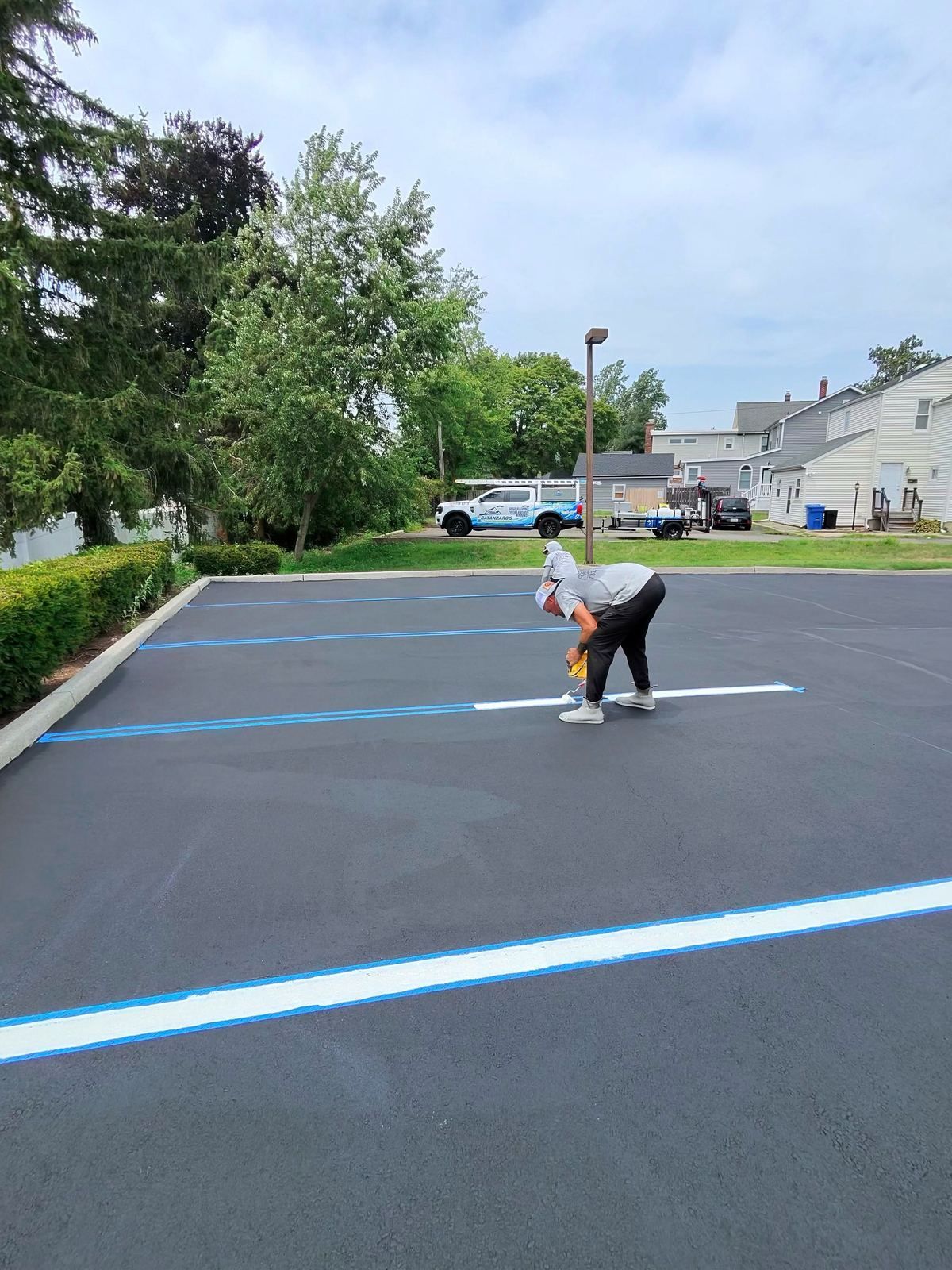 Crew striping blue lot lines — Catanzaro's Power Washing