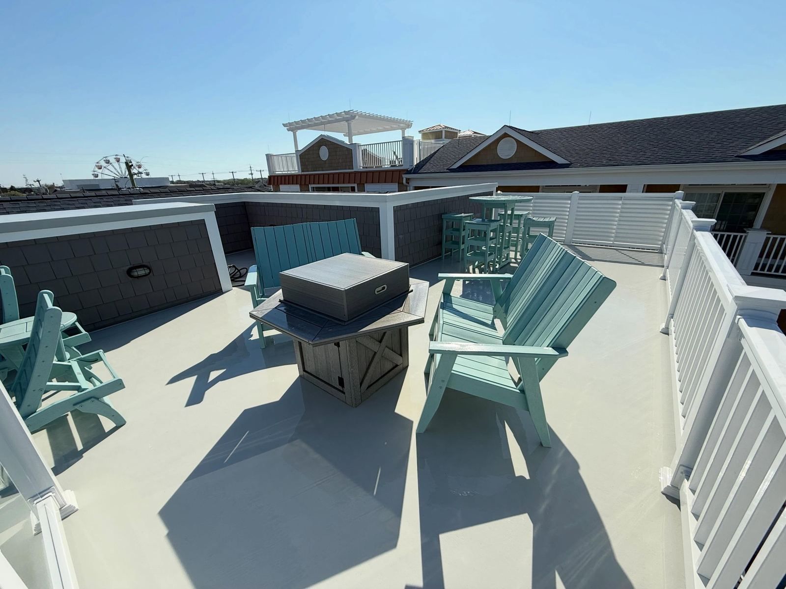 Rooftop deck with teal chairs, ocean view — Catanzaro's Power Washing
