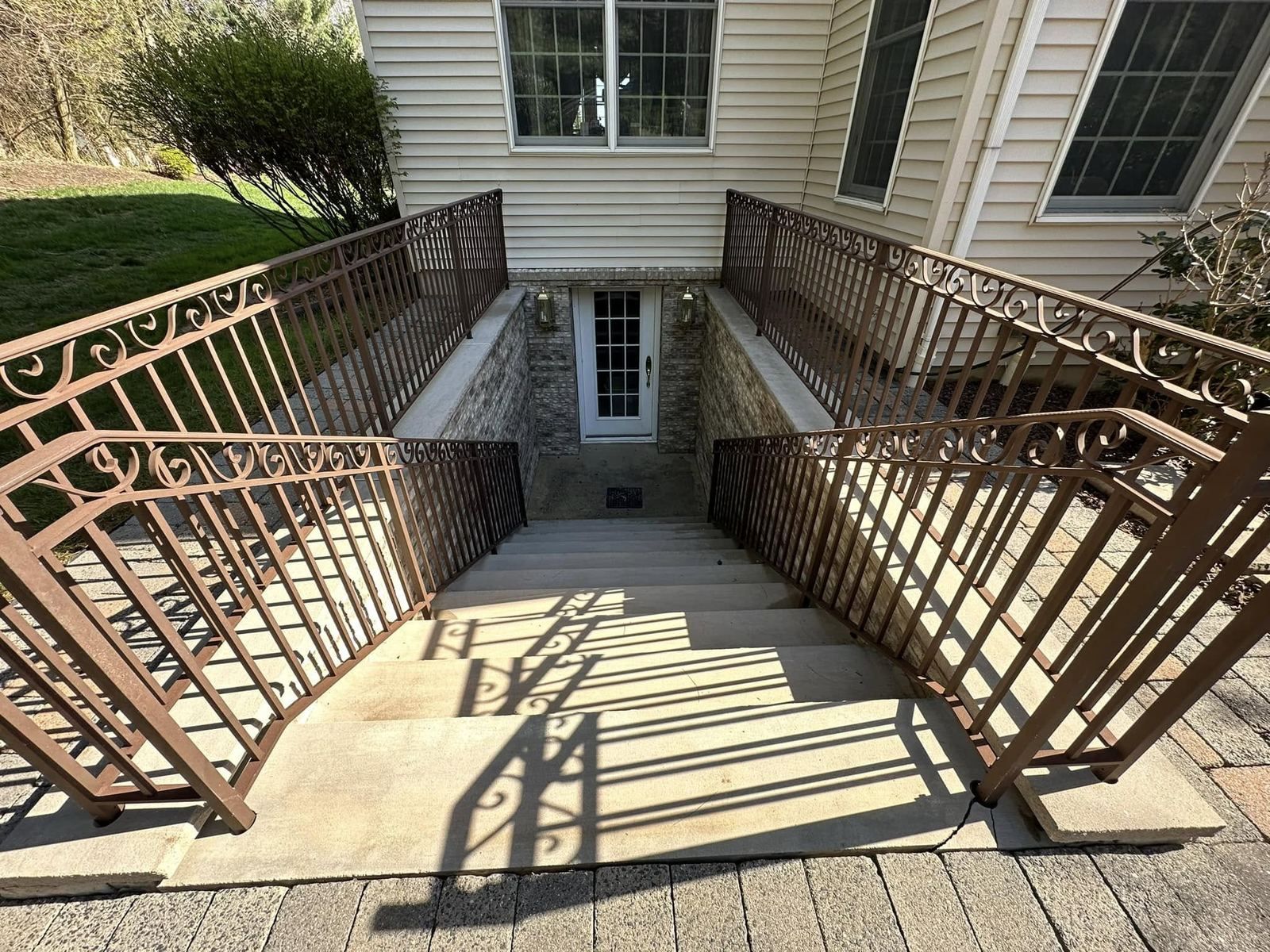 Concrete basement stairwell with railings — Catanzaro's Power Washing