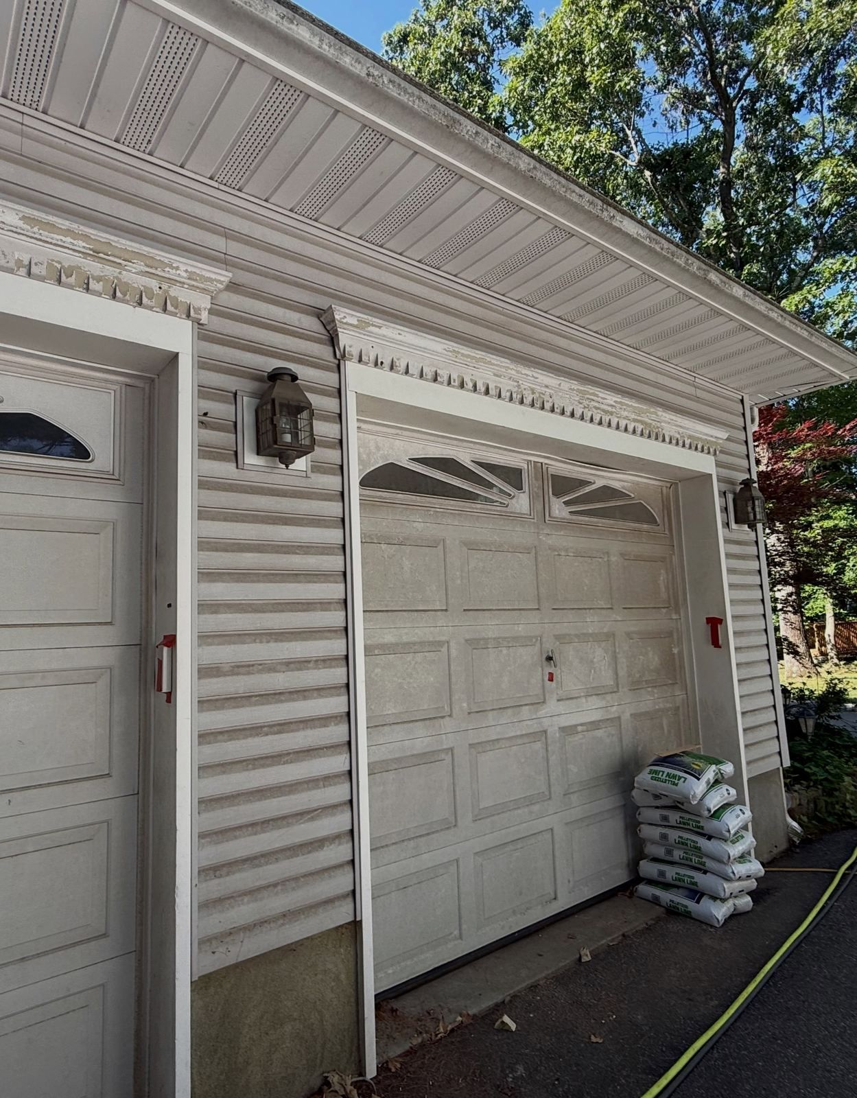 Garage doors and driveway, hose laid out — Catanzaro's Power Washing