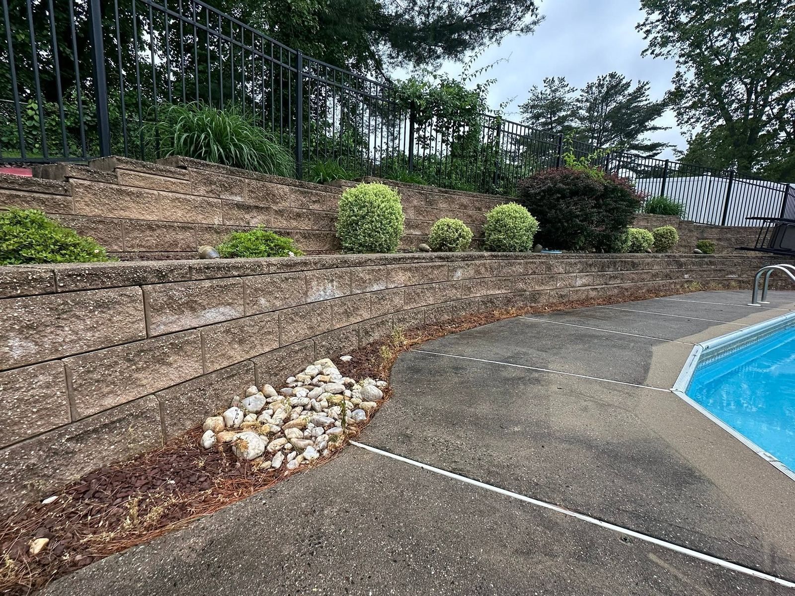 Pool deck concrete and retaining wall, before — Catanzaro's Power Washing