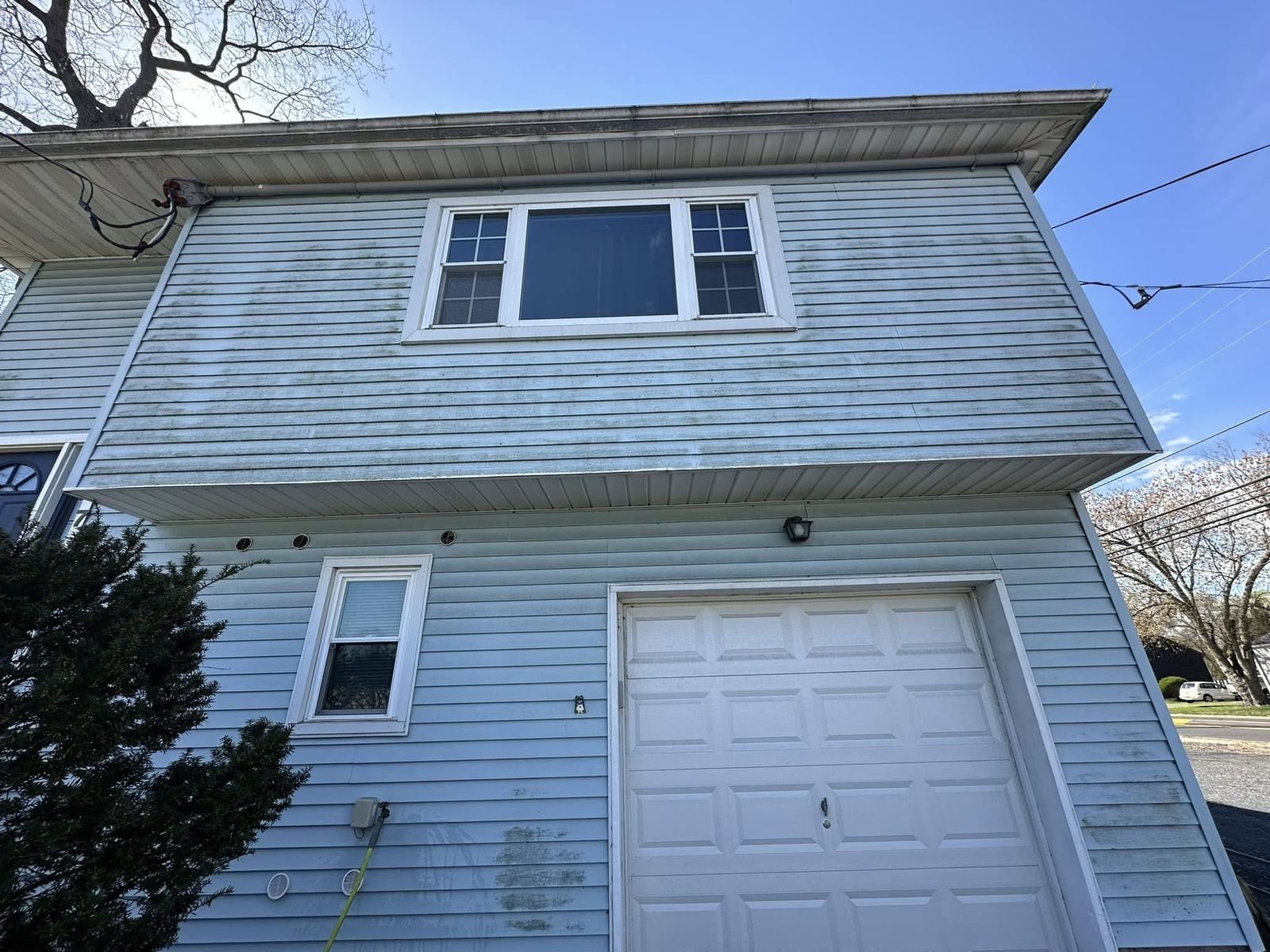 Blue vinyl two-story with garage door — Catanzaro's Power Washing