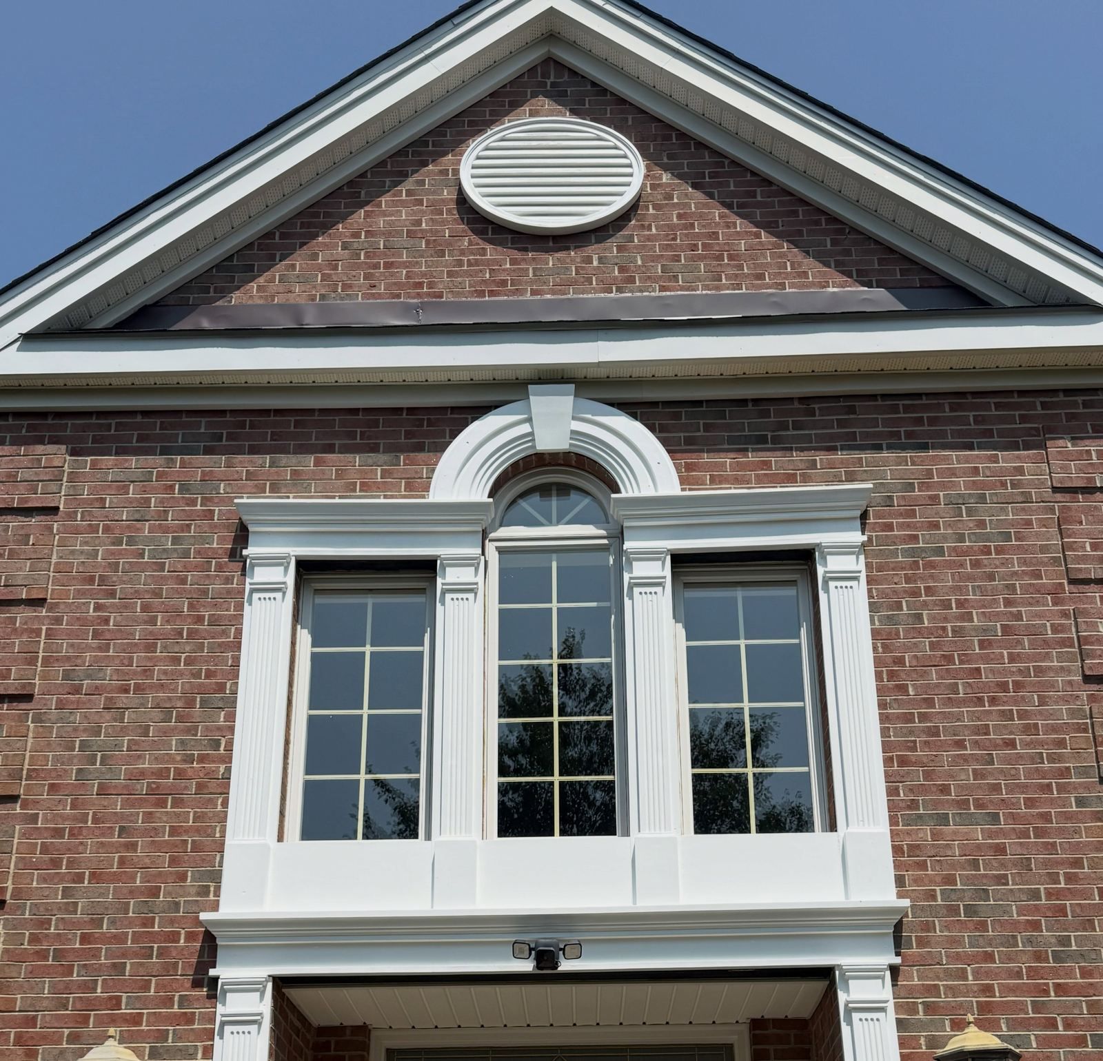 Brick gable with white window trim — Catanzaro's Power Washing