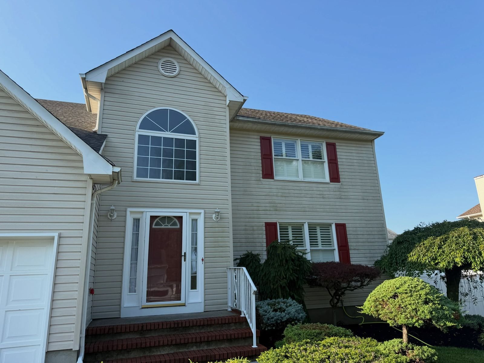 Colonial with arched window and red door — Catanzaro's Power Washing