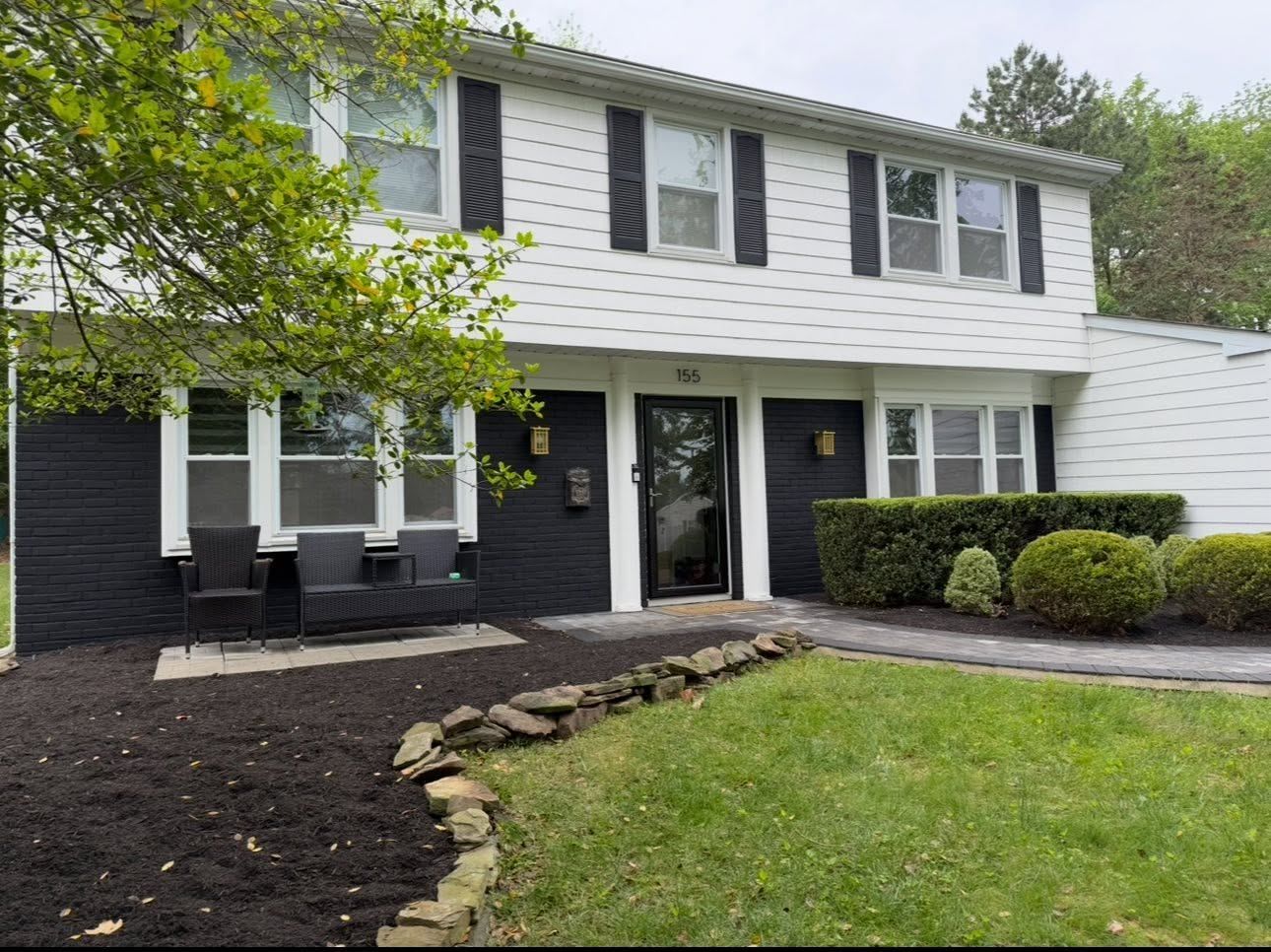 Colonial with dark lower siding and fresh mulch — Catanzaro's Power Washing