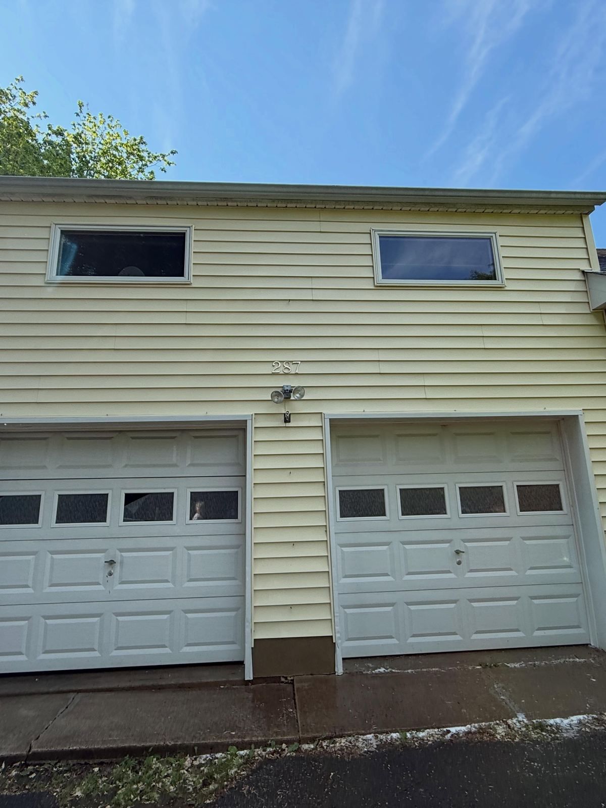 Garage siding with two doors, washed — Catanzaro's Power Washing