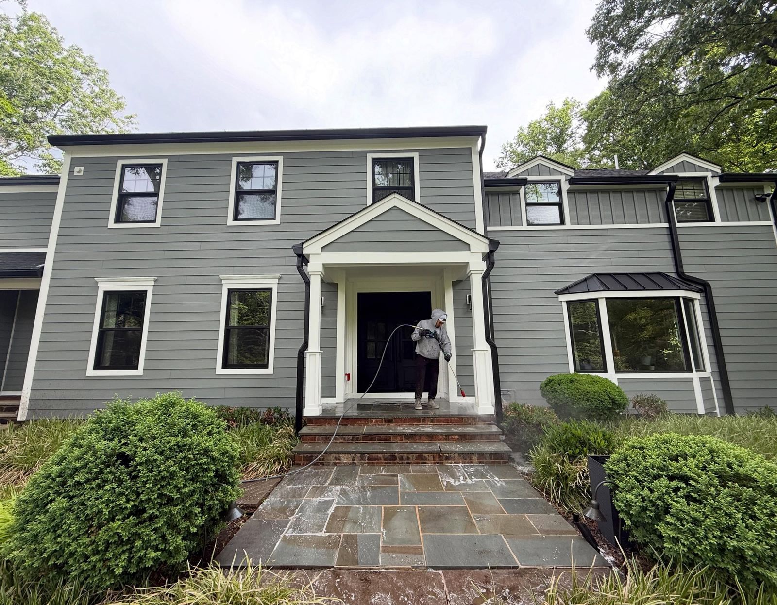 Gray colonial front with crew at door — Catanzaro's Power Washing