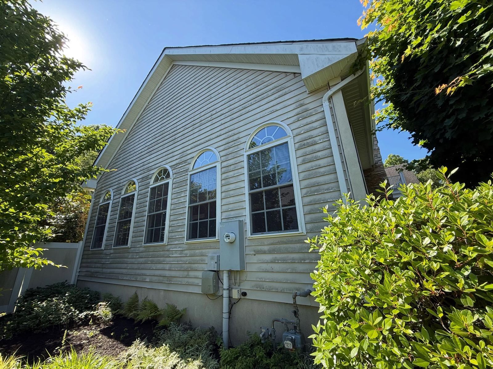 Siding with arched windows, low angle — Catanzaro's Power Washing