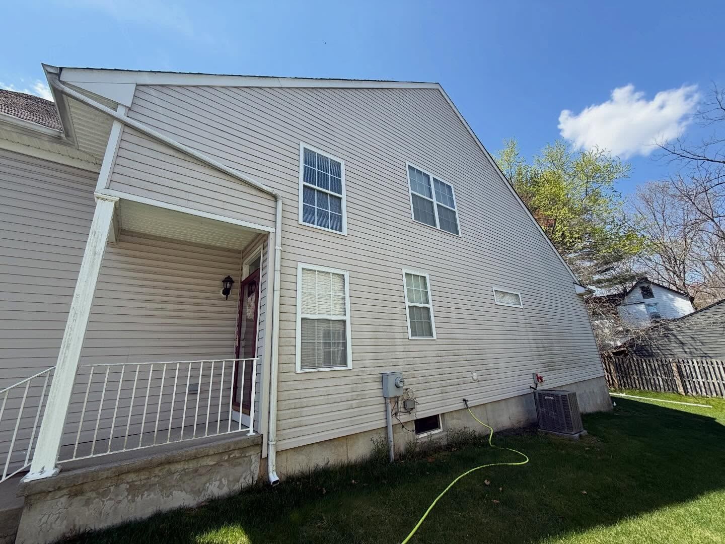 Siding side with porch, hose in yard — Catanzaro's Power Washing