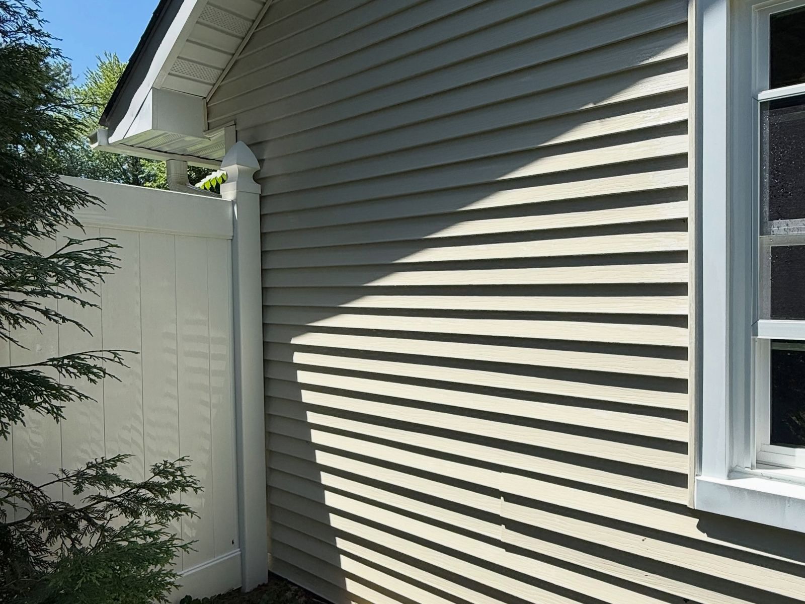 Siding and white fence corner, washed — Catanzaro's Power Washing