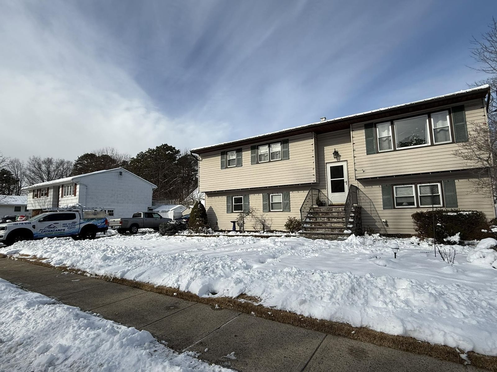 Split-level house in winter snow — Catanzaro's Power Washing
