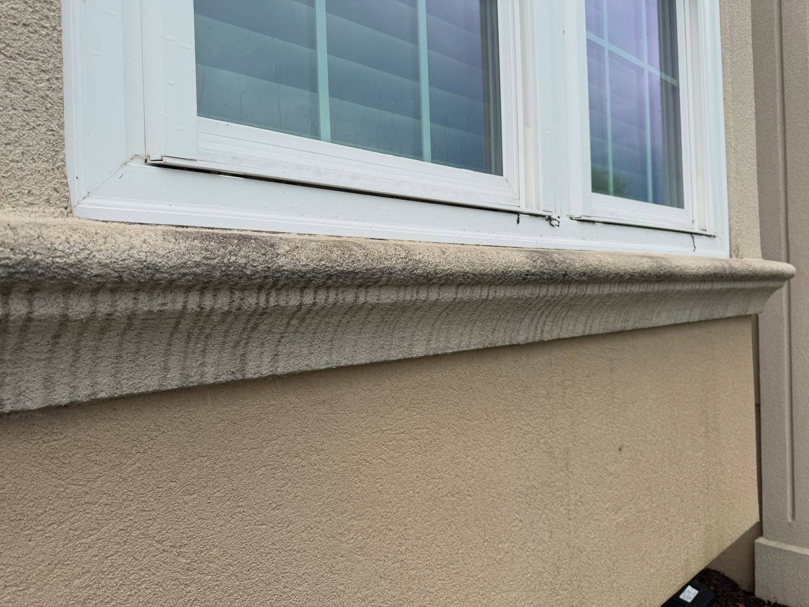 Stucco window sill close-up, cleaned — Catanzaro's Power Washing
