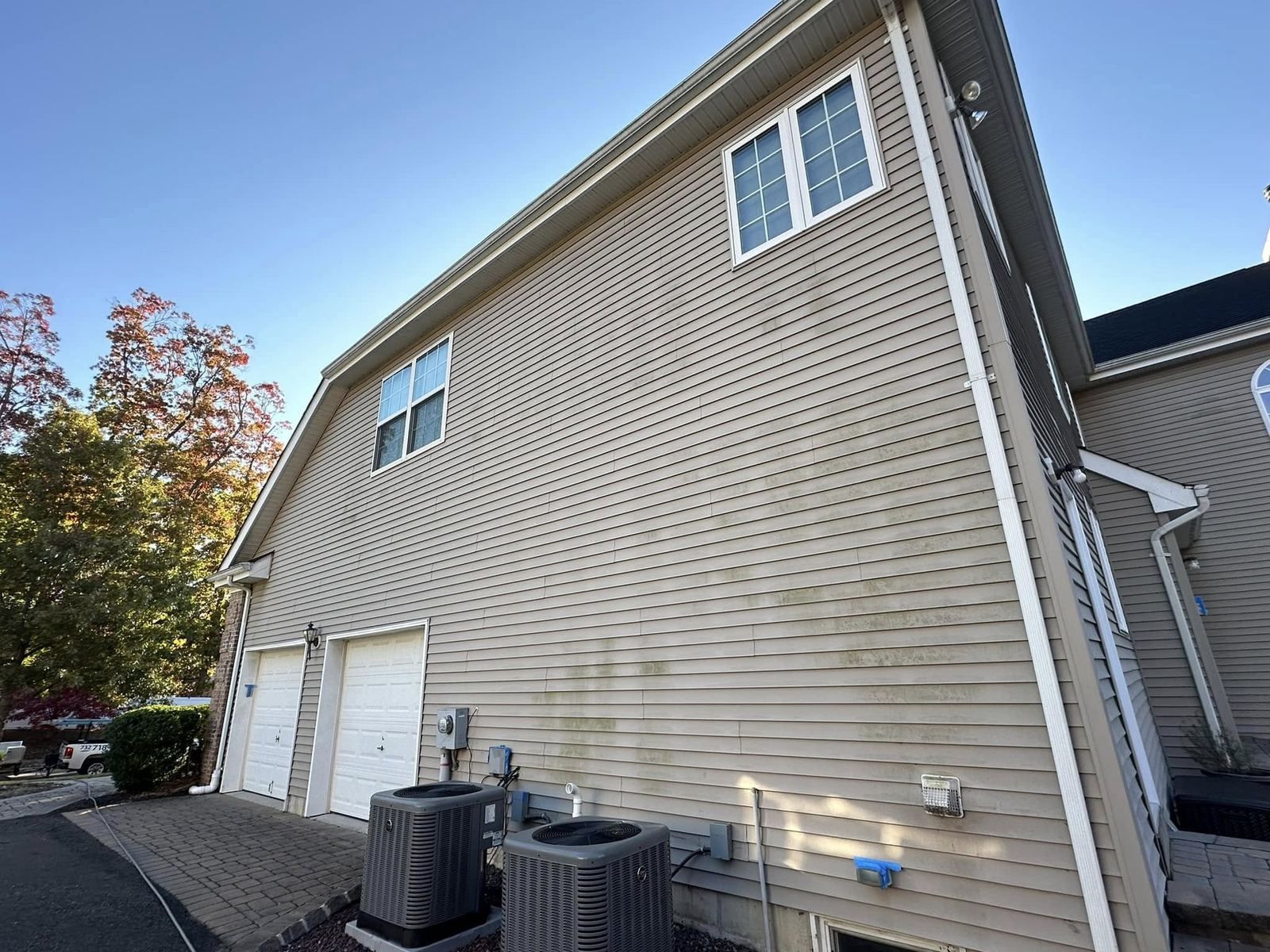 Tall siding wall with garage, low angle — Catanzaro's Power Washing