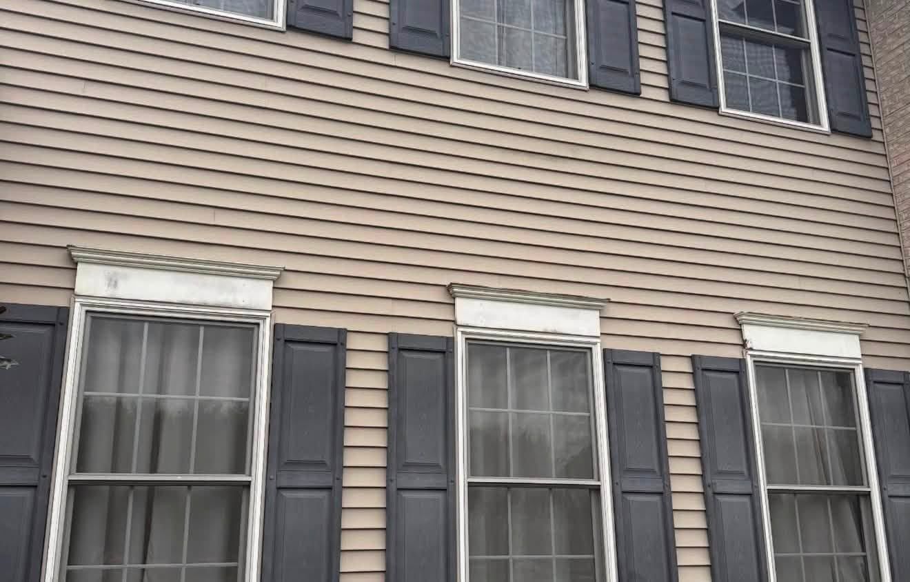 Tan siding with black shutters — Catanzaro's Power Washing