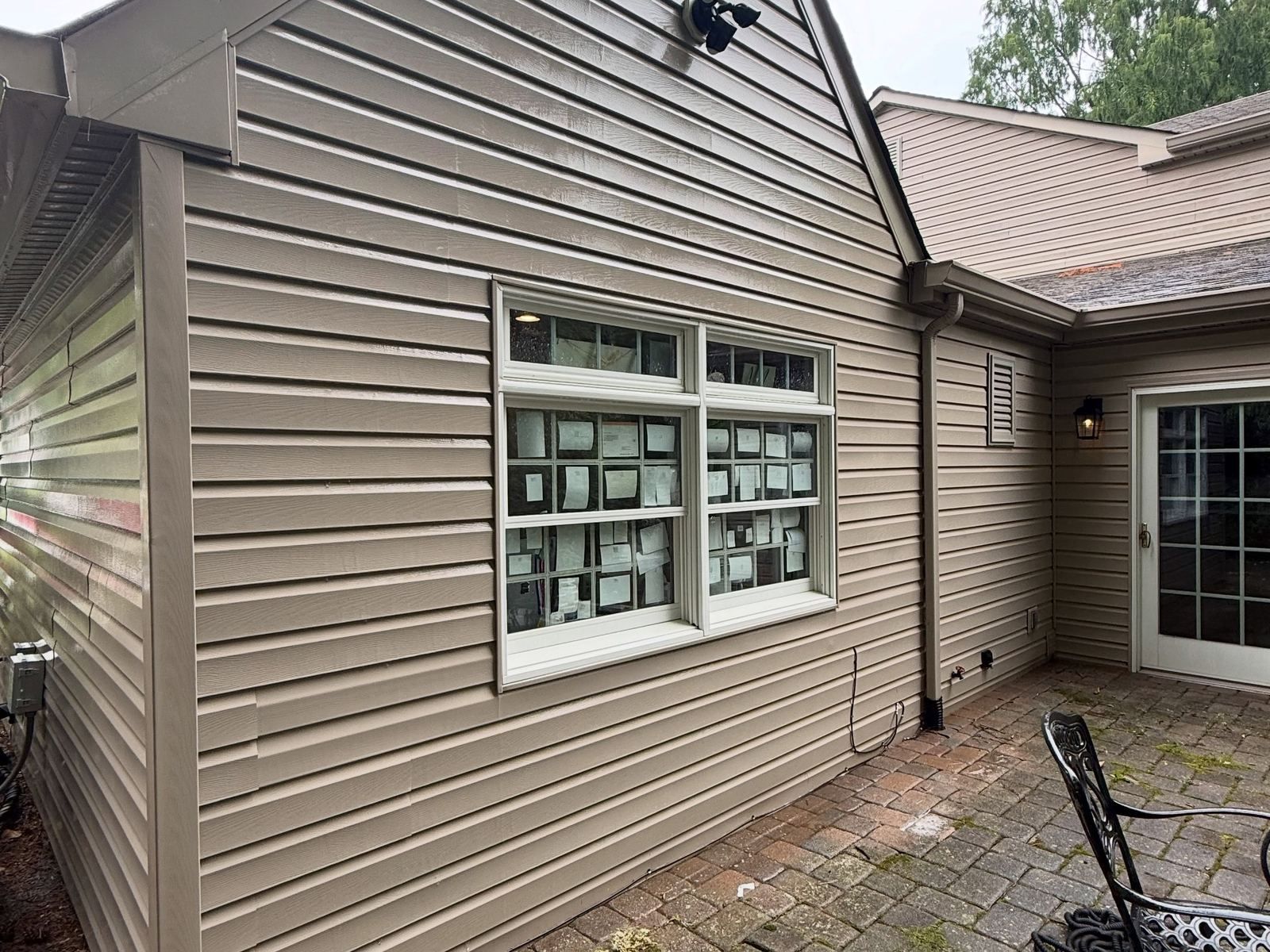 Tan siding wall with windows, after — Catanzaro's Power Washing