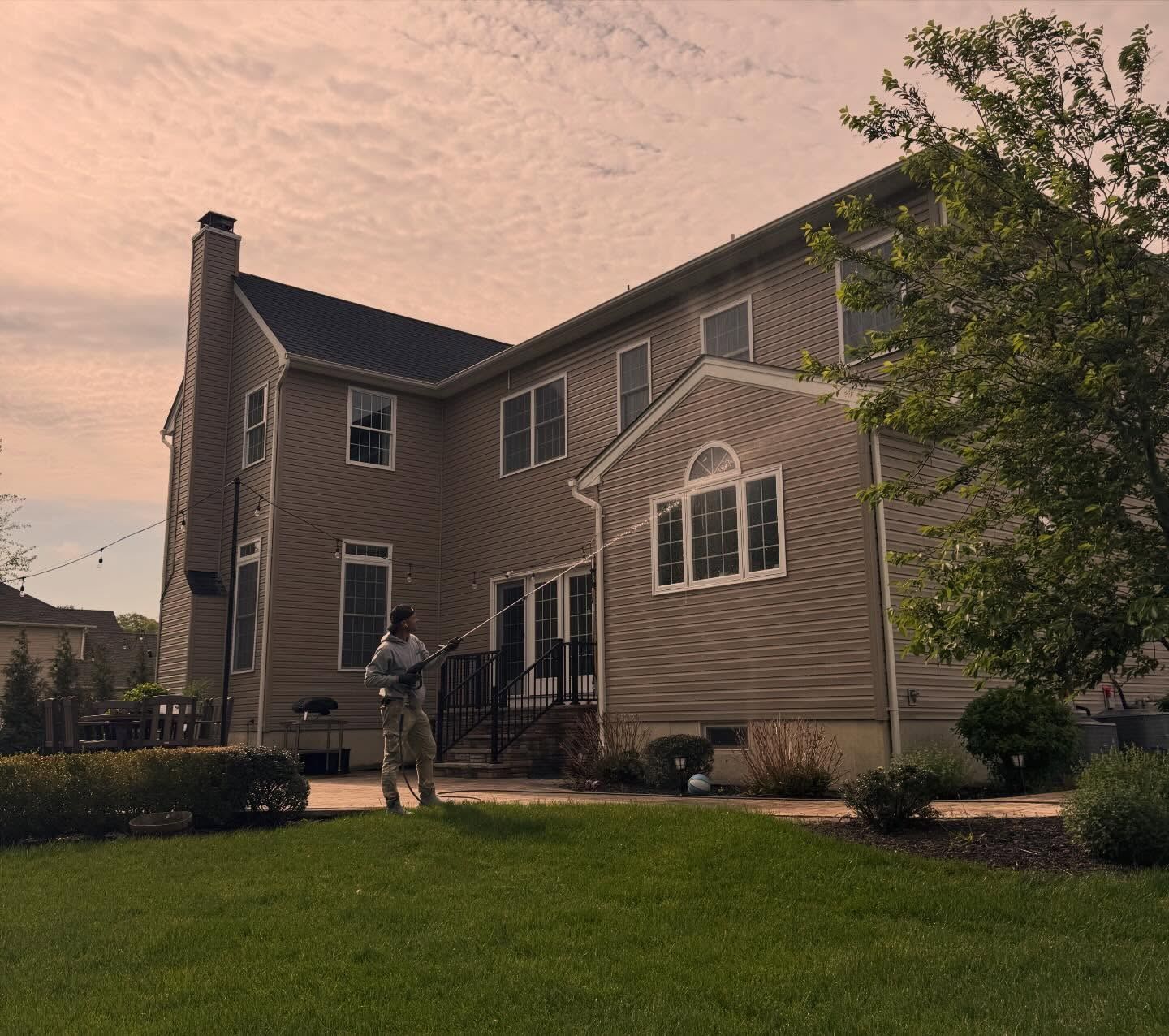 Tan two-story rear at dusk — Catanzaro's Power Washing
