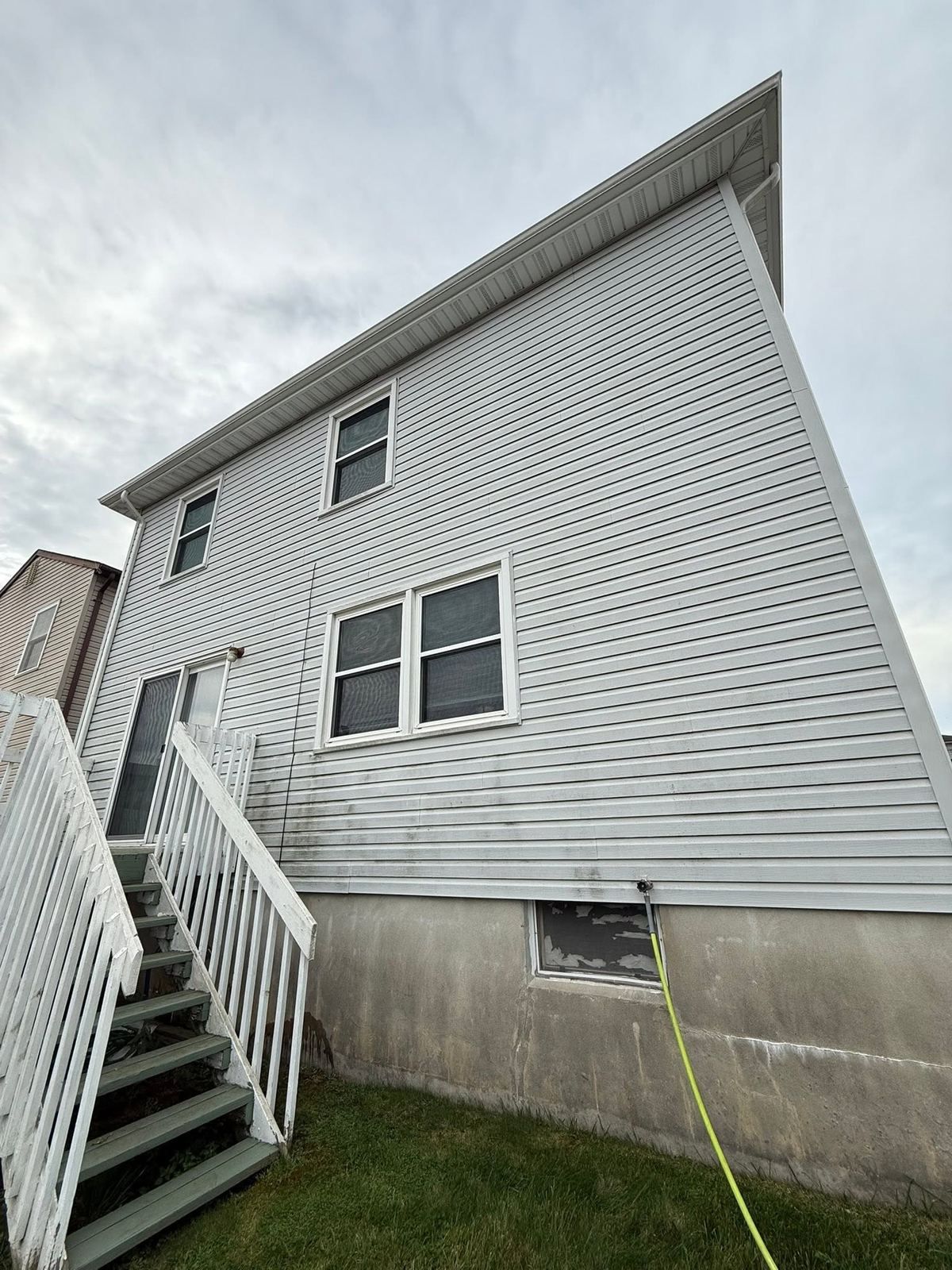 Two-story side with deck stairs — Catanzaro's Power Washing