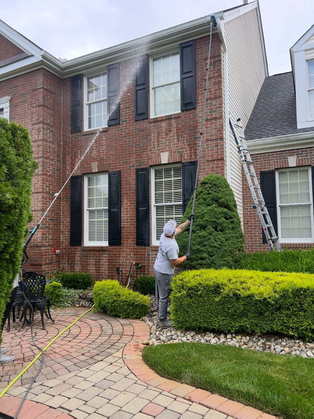 Crew washing brick colonial with wand — Catanzaro's Power Washing