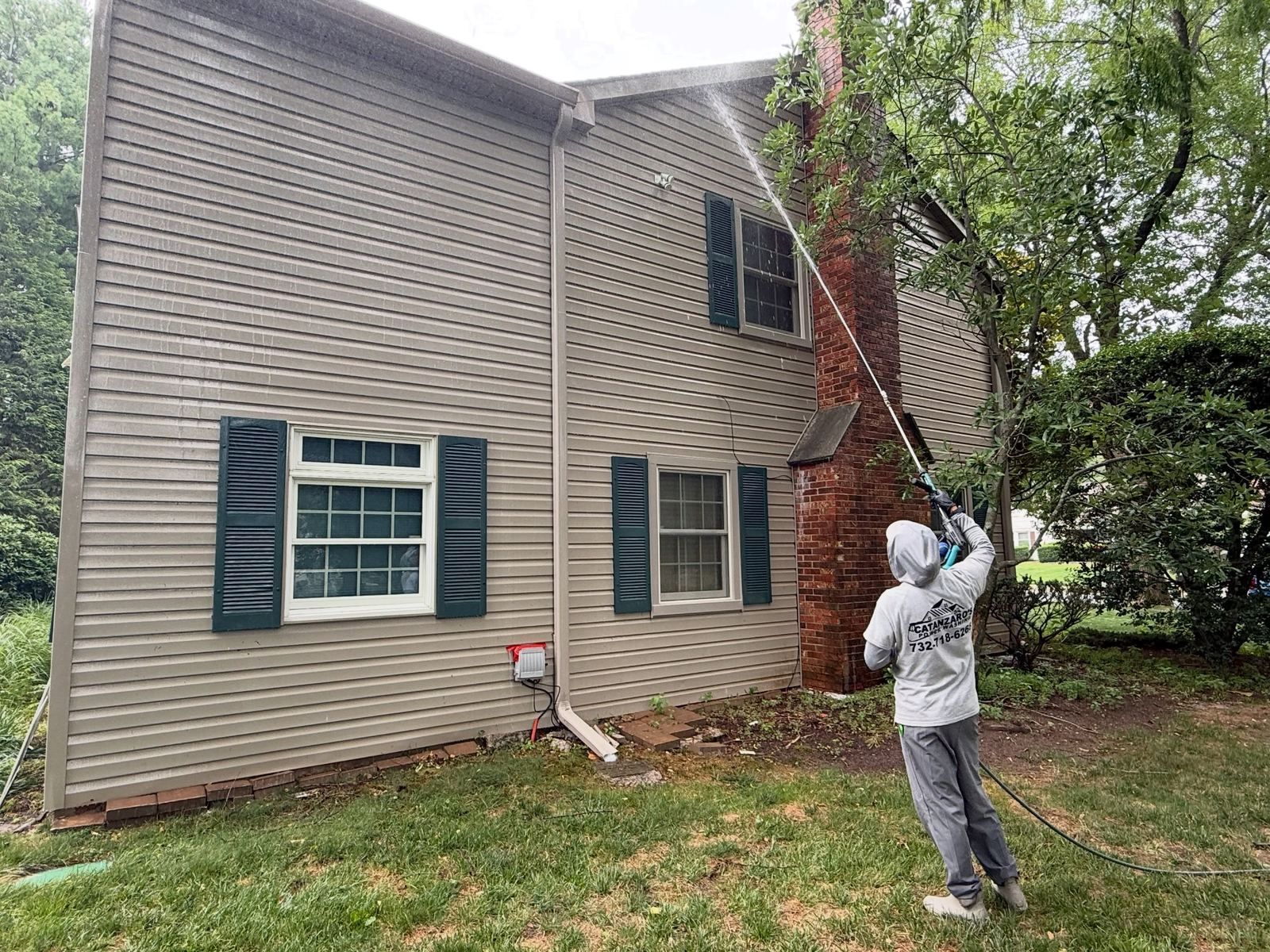 Crew washing colonial with brick chimney — Catanzaro's Power Washing