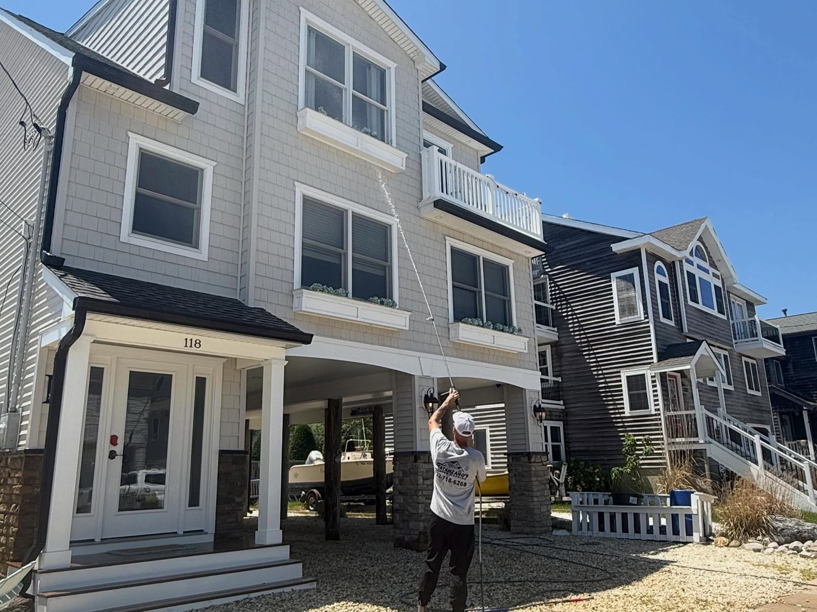 Crew washing gray shore house siding — Catanzaro's Power Washing