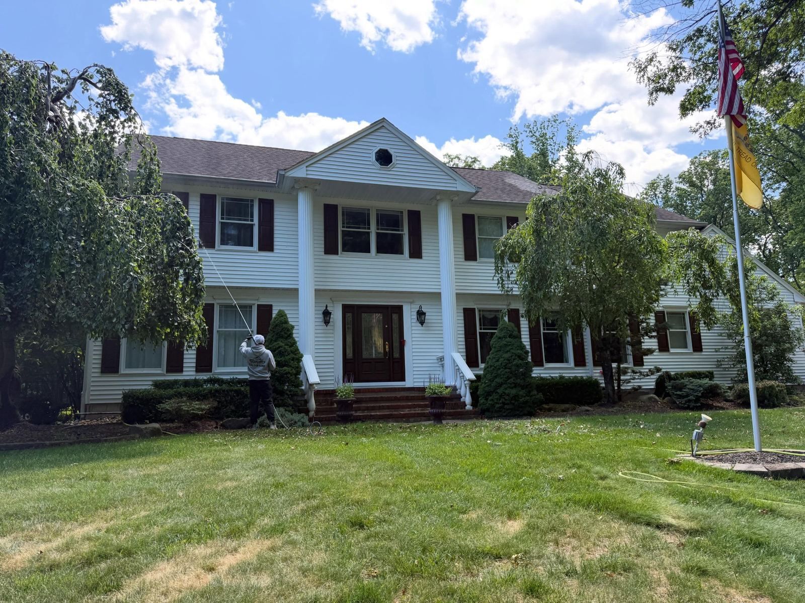 White colonial with flag, front lawn — Catanzaro's Power Washing
