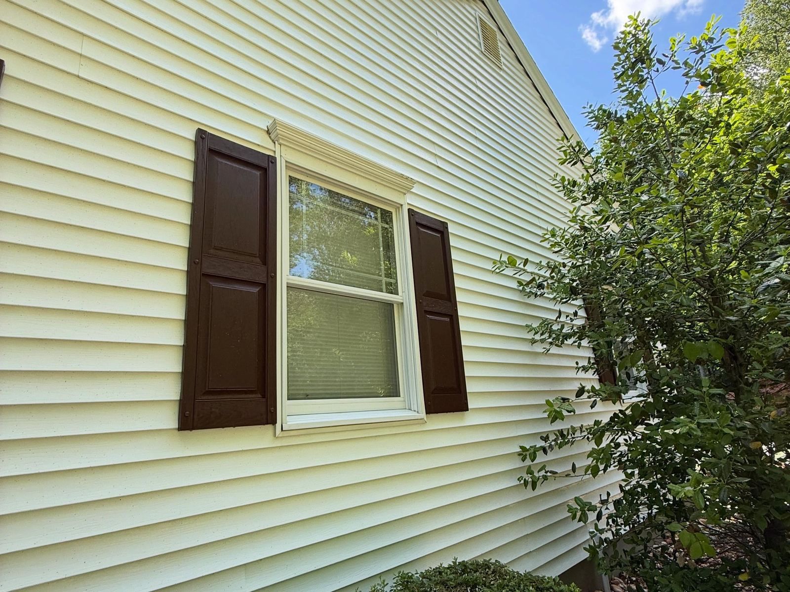 Yellow siding with brown shutters — Catanzaro's Power Washing