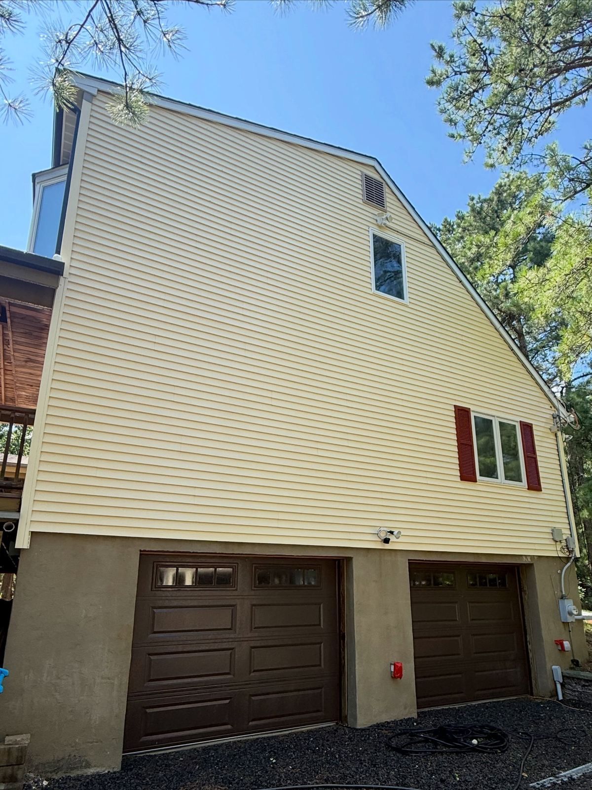Yellow siding over garage, after — Catanzaro's Power Washing