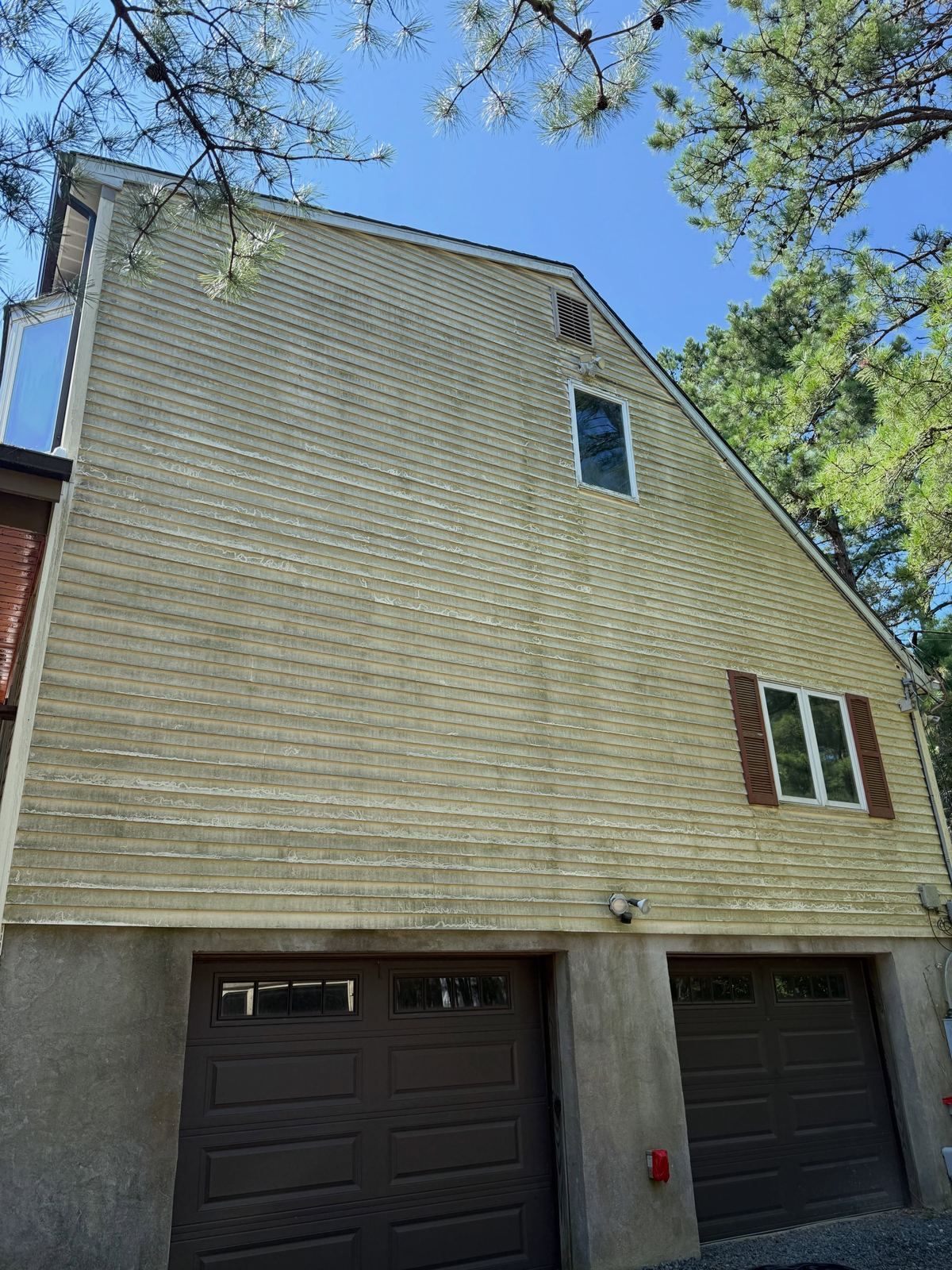 Yellow siding over garage, dirty — Catanzaro's Power Washing